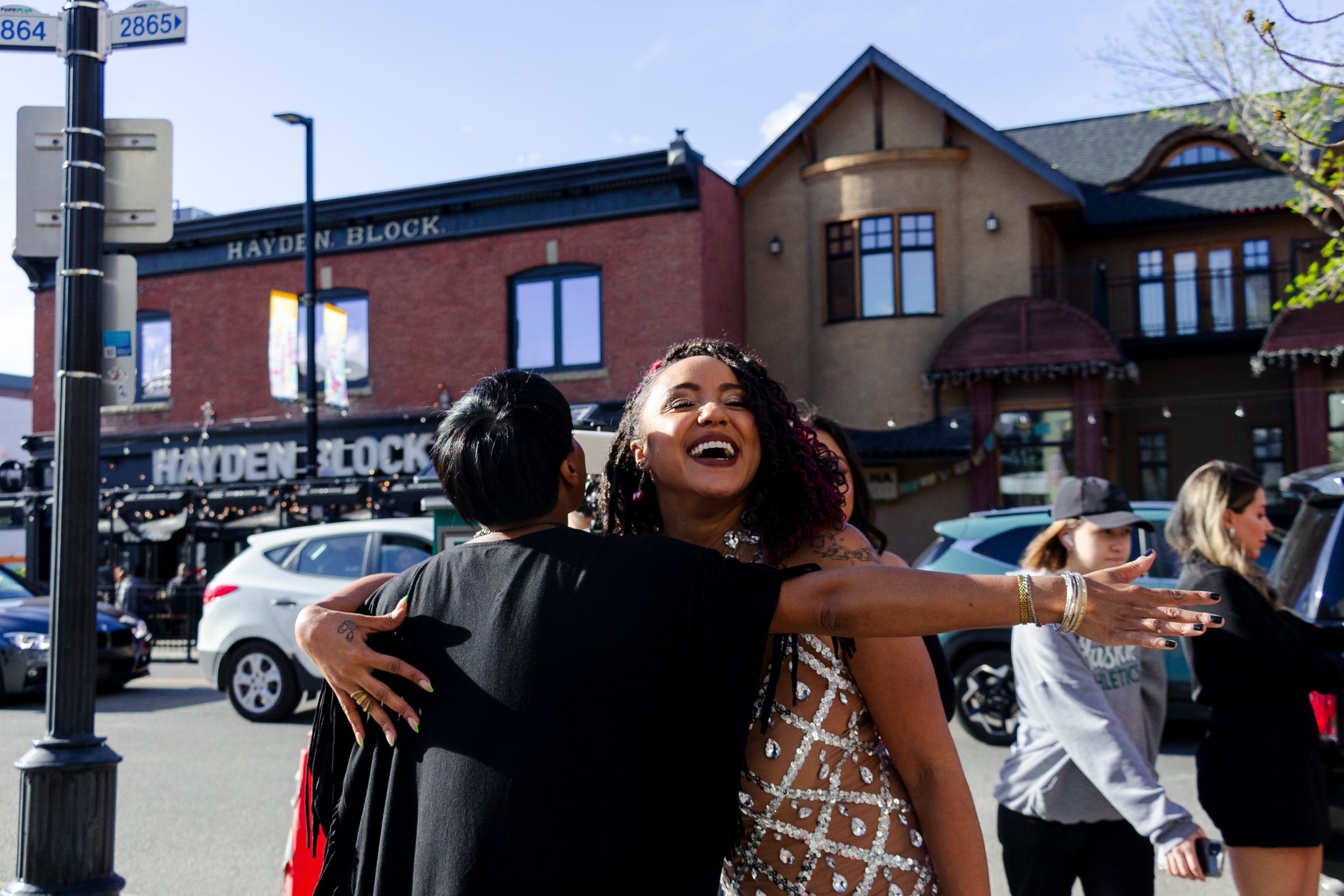 Lisa Jacobs is sharing a warm hug with Priscilla Cherry at the Season 2 Premiere of SHADES.